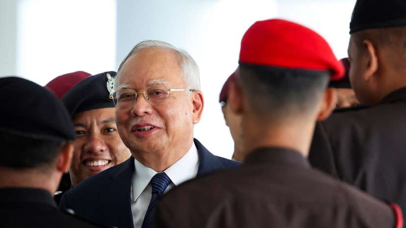 FILE PHOTO: Prison officers escort former Malaysian PM Razak, in Kuala Lumpur