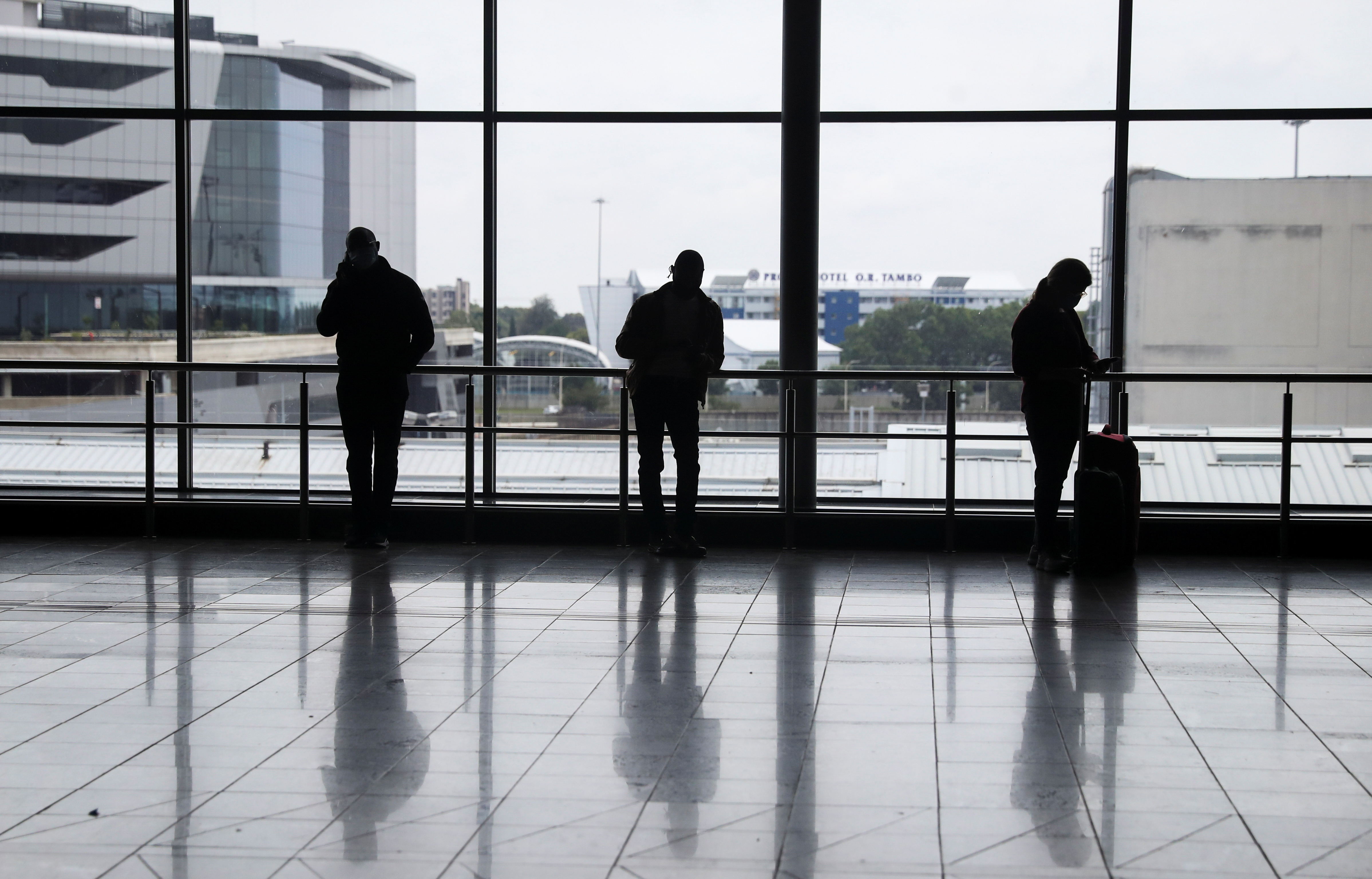 Passengers wait to board international flights, amidst the spread of the new SARS-CoV-2 variant Omicron, at O.R. Tambo International Airport, in Johannesburg