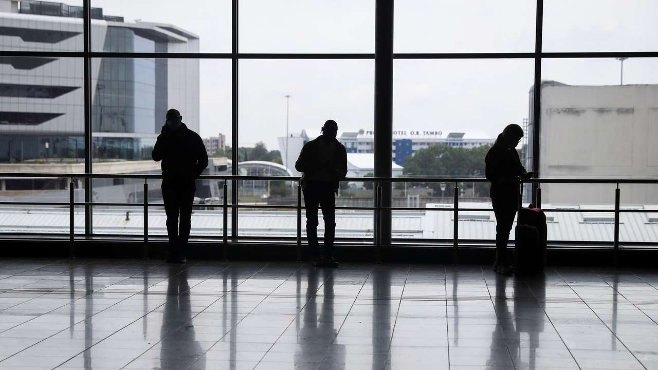Passengers wait to board international flights, amidst the spread of the new SARS-CoV-2 variant Omicron, at O.R. Tambo International Airport, in Johannesburg