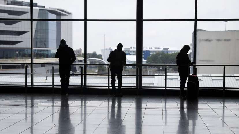 Passengers wait to board international flights, amidst the spread of the new SARS-CoV-2 variant Omicron, at O.R. Tambo International Airport, in Johannesburg