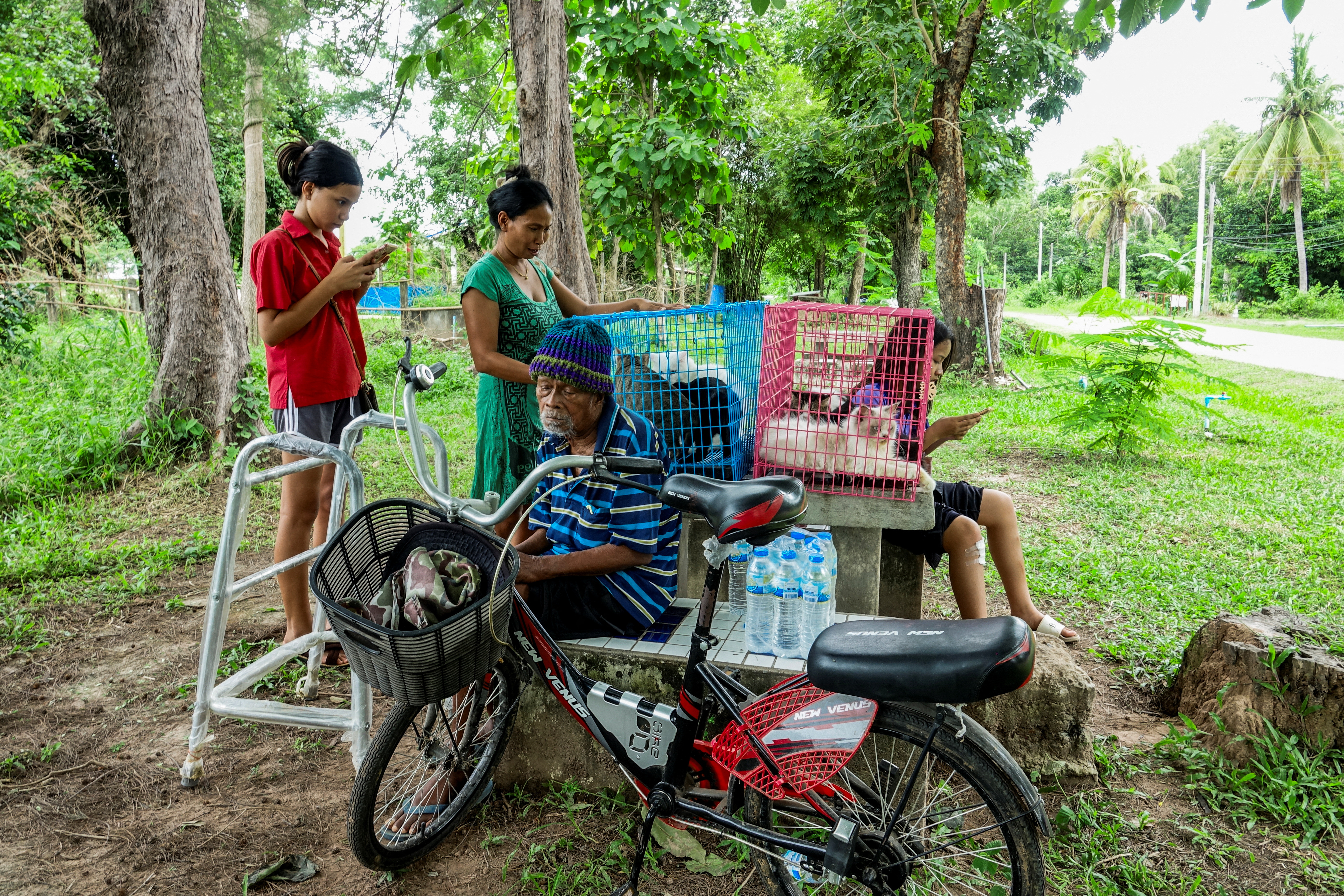 People rest at a shelter amid the clashes between Thailand and Cambodia