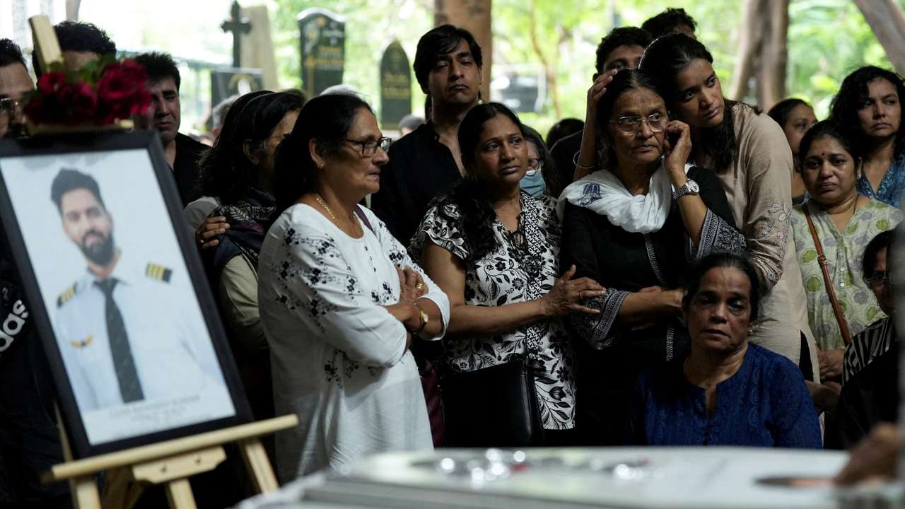 FILE PHOTO: Friends and family members mourn near the coffin of Co-Pilot Clive Kunder, who died after an AIR India Boeing 787-8 Dreamliner plane crashed during take-off from an airport in Ahmedabad, in Mumbai