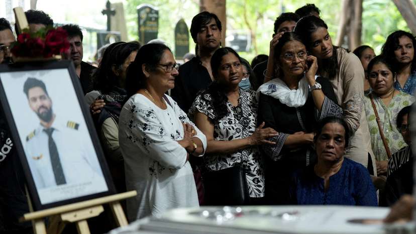 FILE PHOTO: Friends and family members mourn near the coffin of Co-Pilot Clive Kunder, who died after an AIR India Boeing 787-8 Dreamliner plane crashed during take-off from an airport in Ahmedabad, in Mumbai