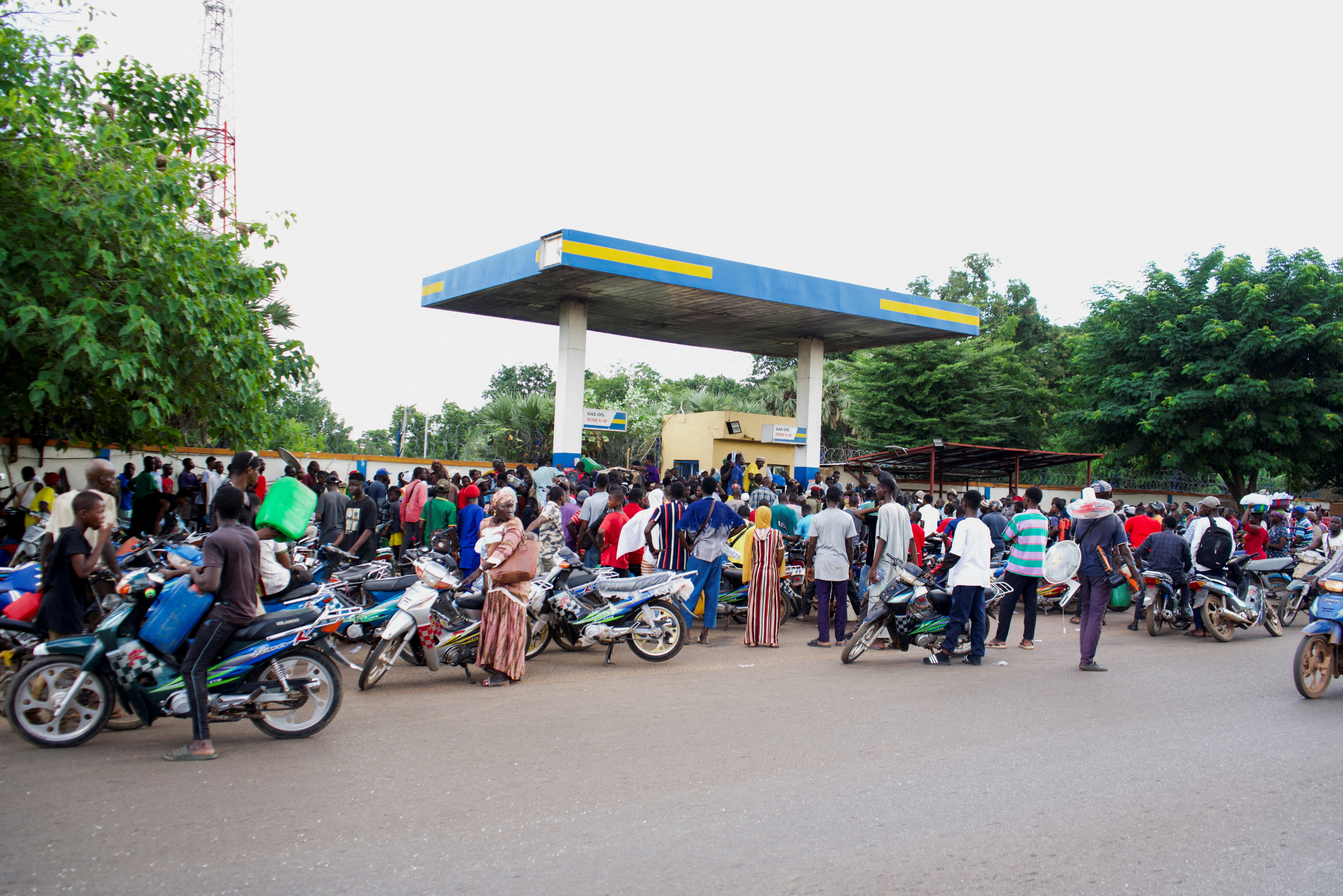 FILE PHOTO: People gather at a petrol station due to shortage of petrol in Bamako