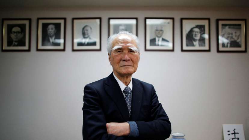 Former Japanese PM Murayama poses in front of portraits of former leaders of his Social Democratic Party after an interview with Reuters at the party headquarters in Tokyo