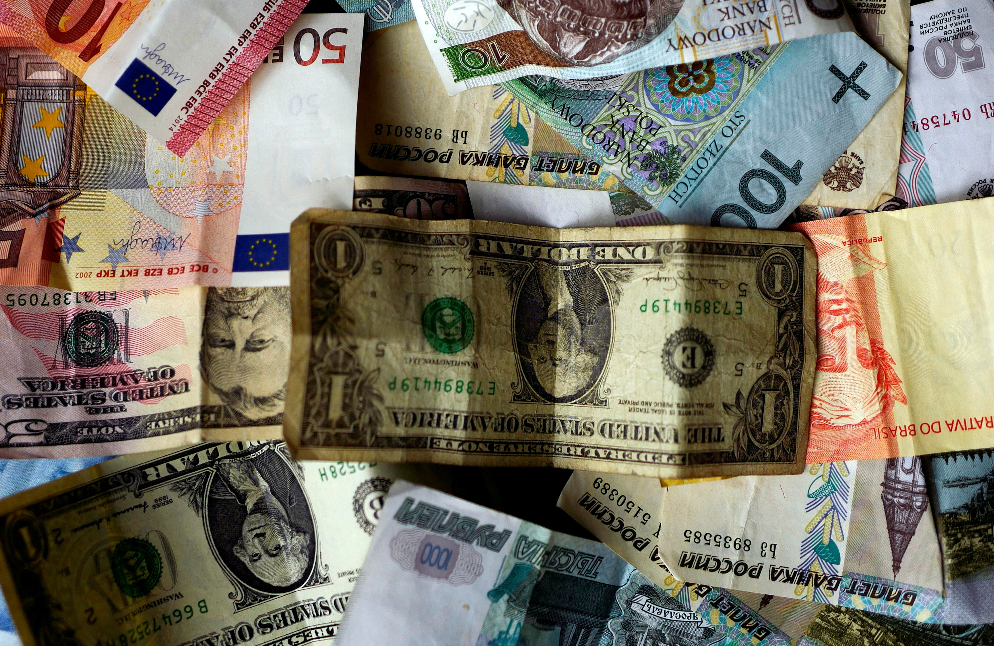 FILE PHOTO: Bank notes of different currencies are photographed in Frankfurt, Germany, in this illustration picture