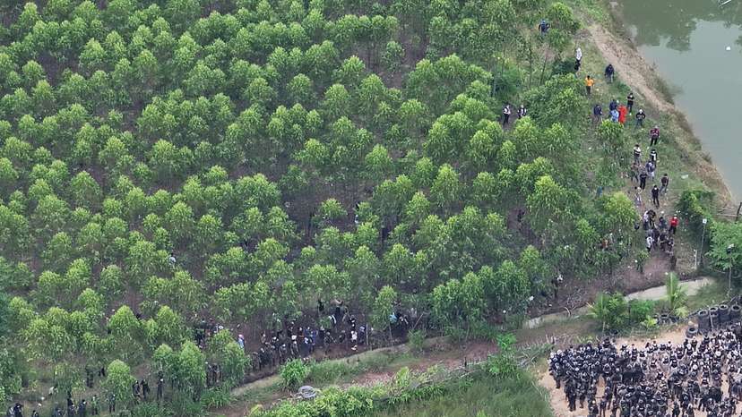 A drone view shows Thai soldiers and riot police officers confronting Cambodian people in a disputed village along the Thailand-Cambodia border in Sa Kaeo province