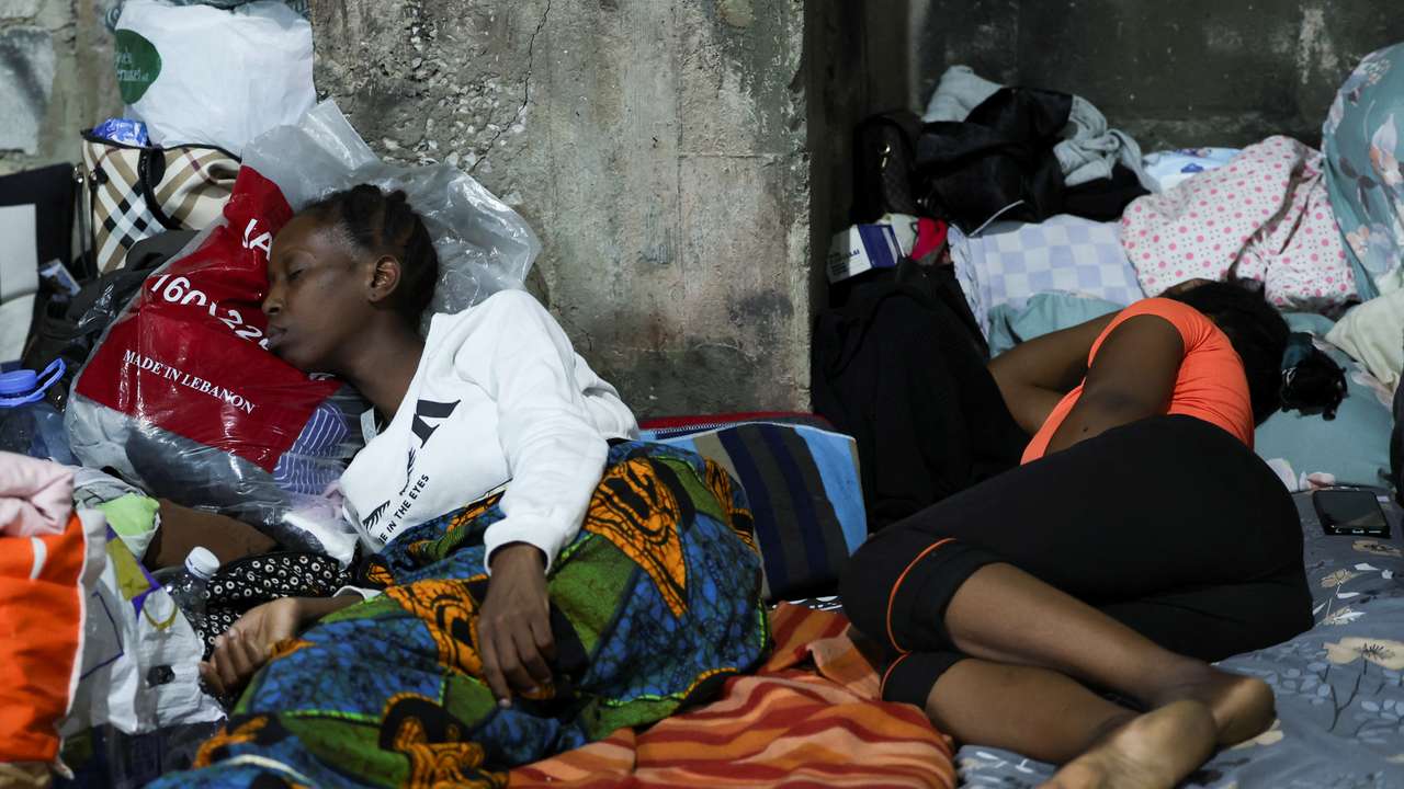 Two women from Sierra Leone sleep on a mattress at a shelter for displaced migrant workers in Hazmieh,