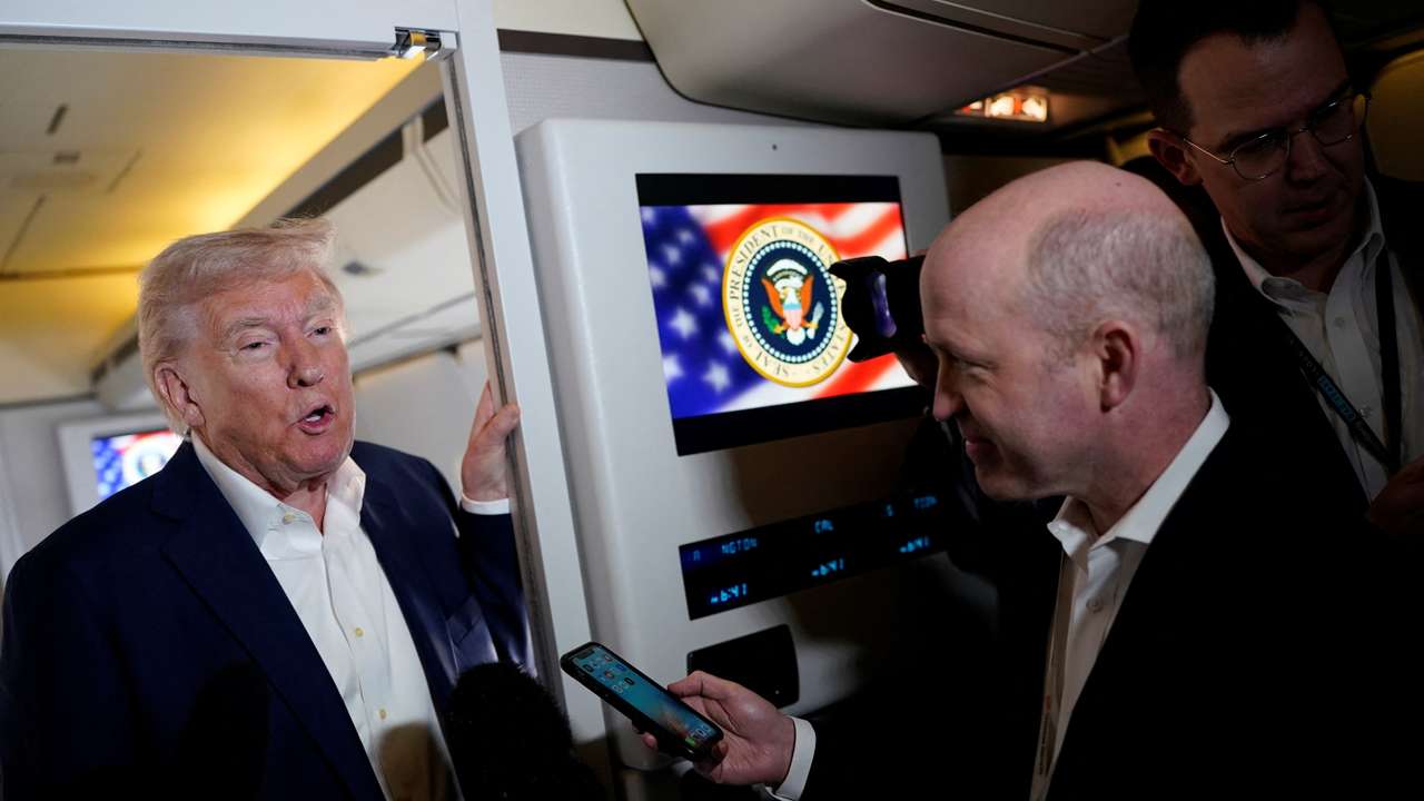 U.S. President Donald Trump walks on board Air Force One on the way to Palm Beach International Airport