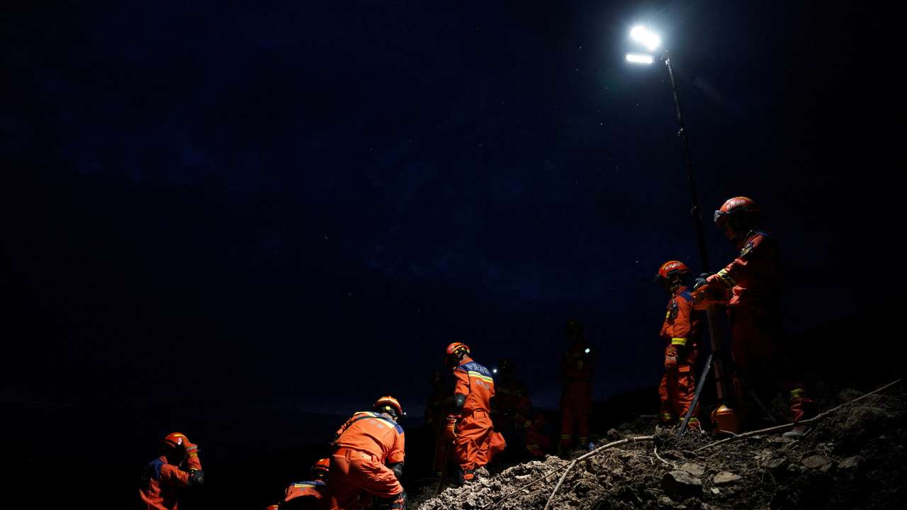 Firefighters conduct a rescue operation following a landslide in Qingyang village of Bijie
