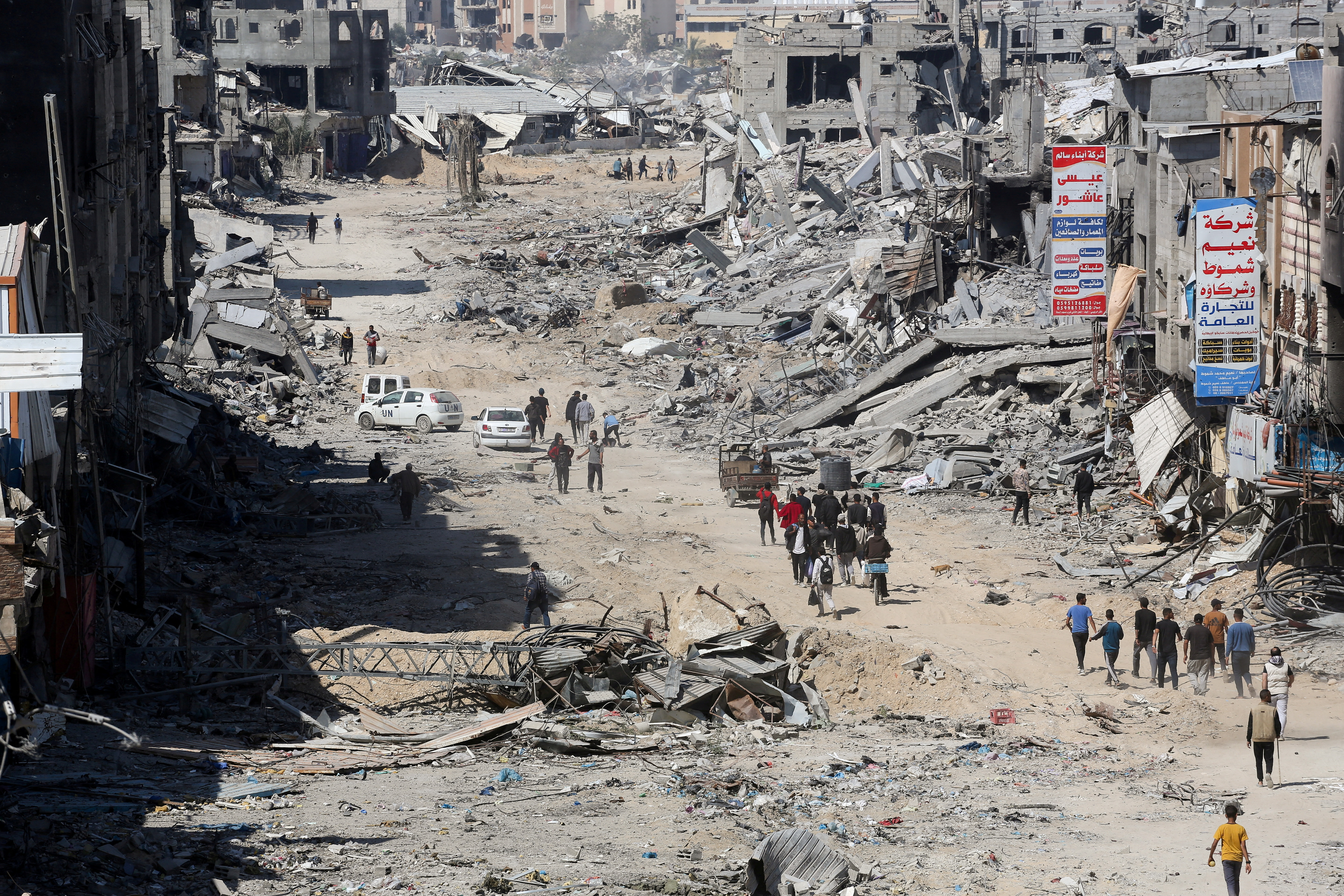 Palestinians inspect destroyed residential buildings in Khan Younis