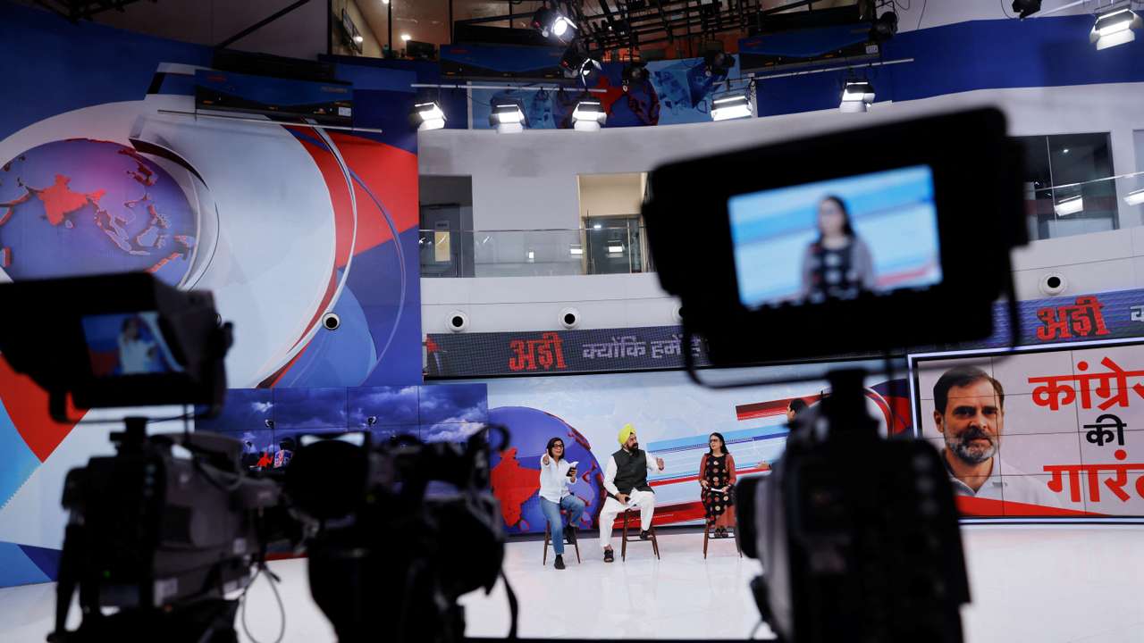 Neha Singh Rathore, 27, a folk singer and social media content creator, reacts during a debate where she was asked to be a panelist, inside the studio of a national television news network in Noida