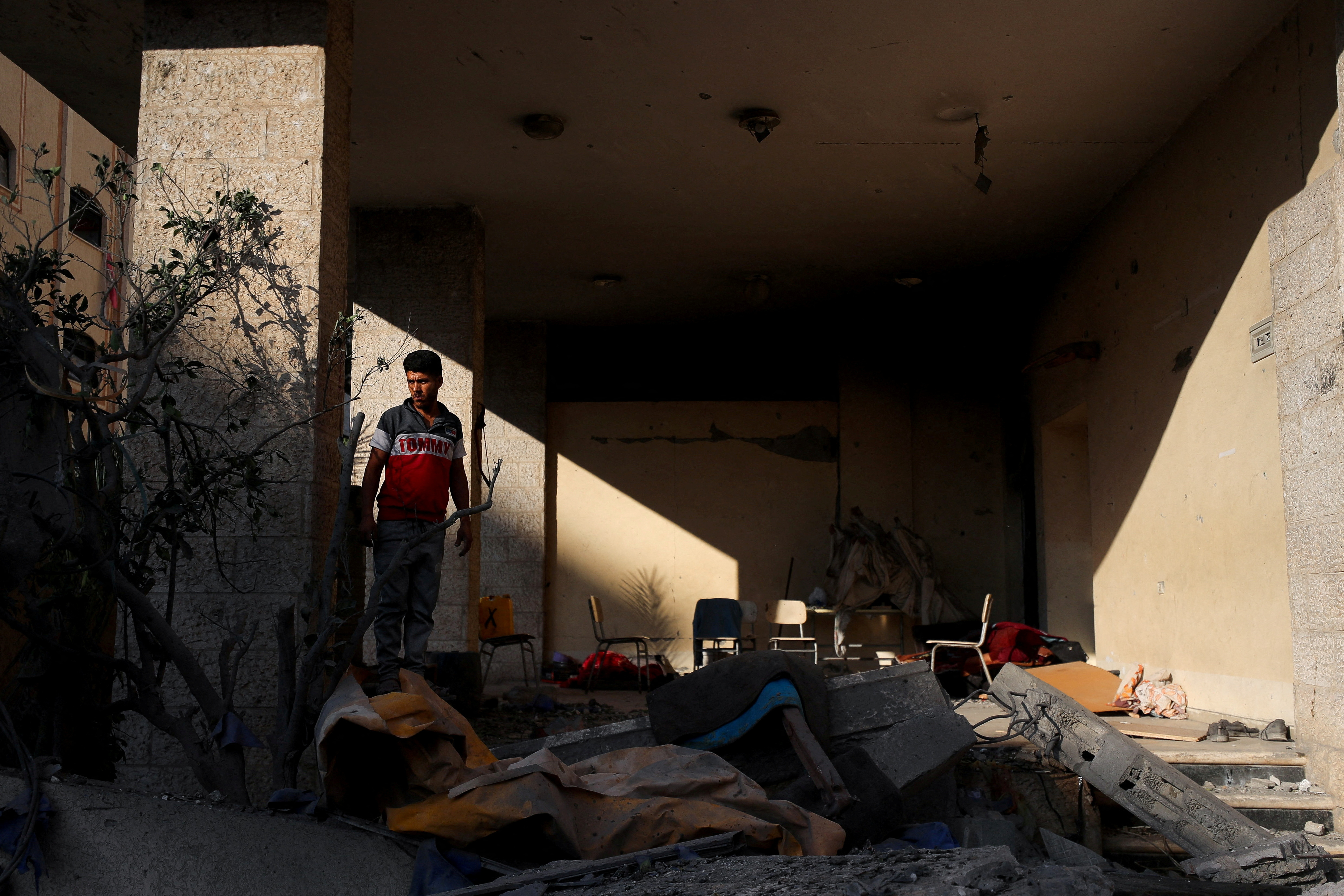 Palestinians inspect the site of an overnight Israeli strike on a house, in Gaza City