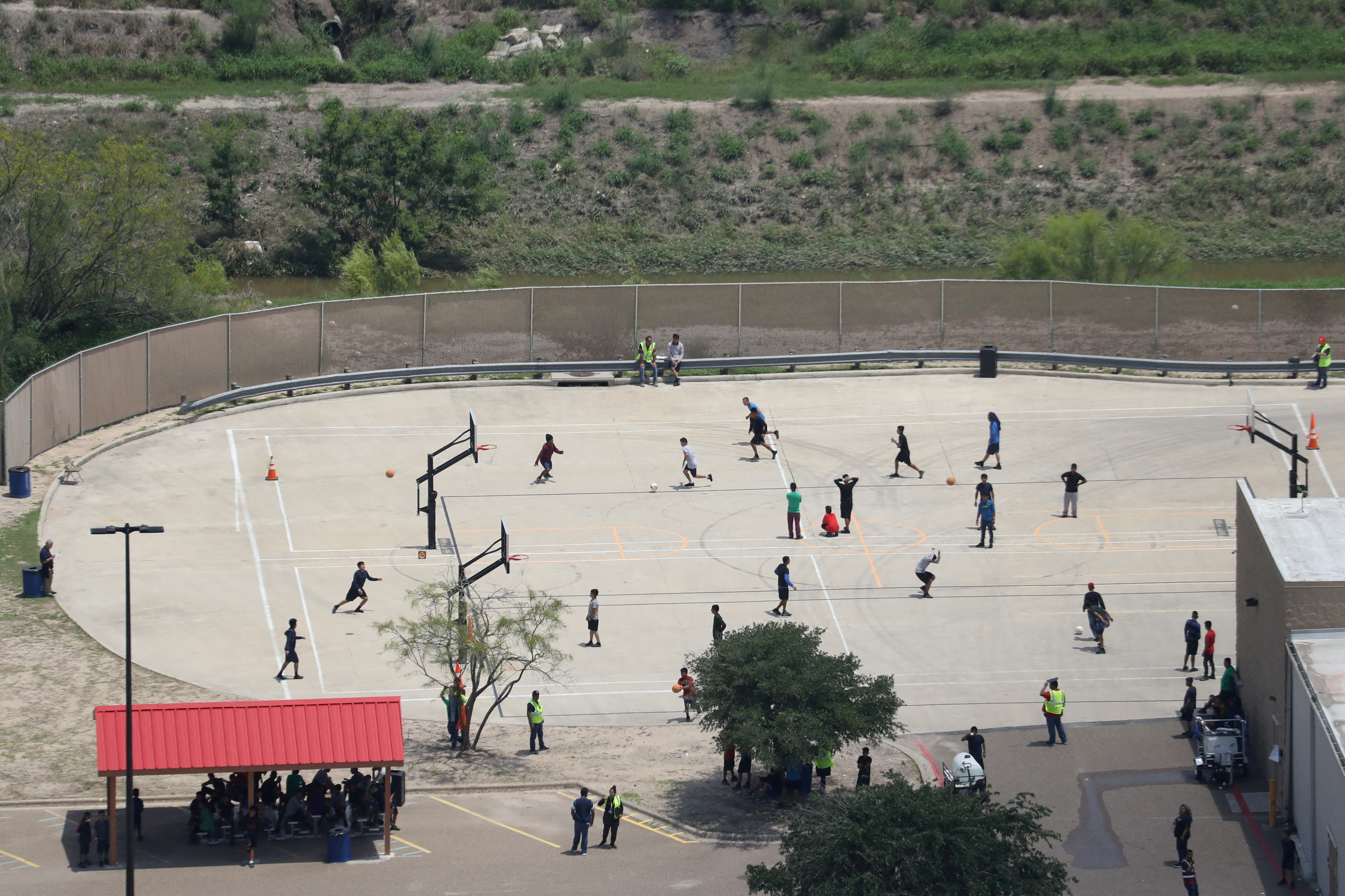 FILE PHOTO: Migrant boys spend time in a recreation area outside Casa Padre, an immigrant shelter for unaccompanied minors, in Brownsville