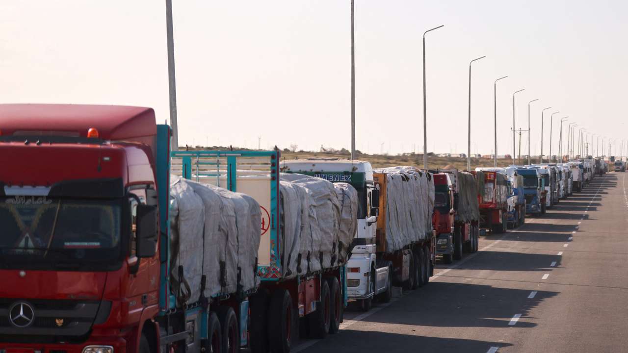 Trucks carrying aid line up near the Rafah border crossing between Egypt and the Gaza Strip