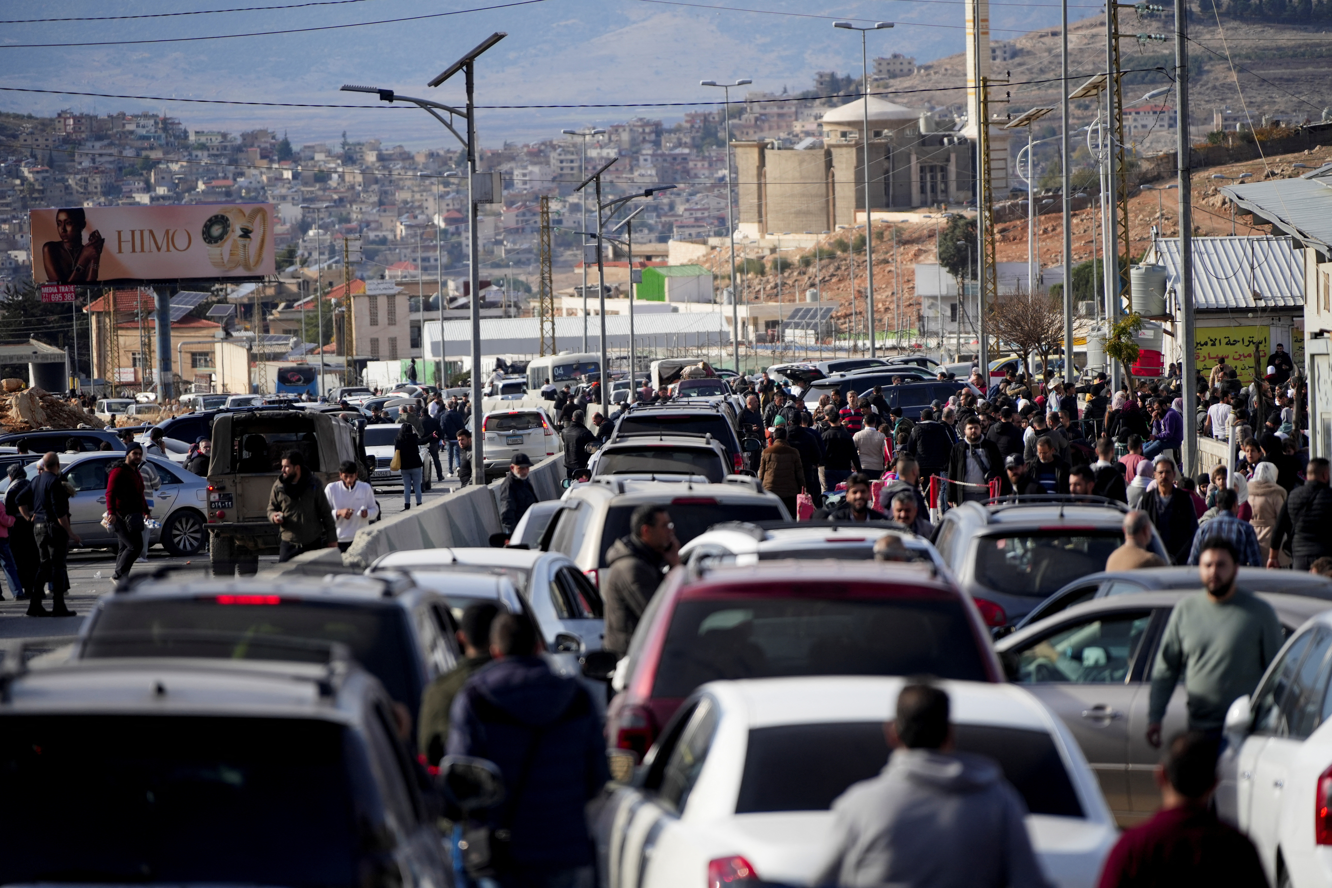 People make their way as they attempt to cross into Lebanon at the Masnaa border crossing between the Lebanon and Syria