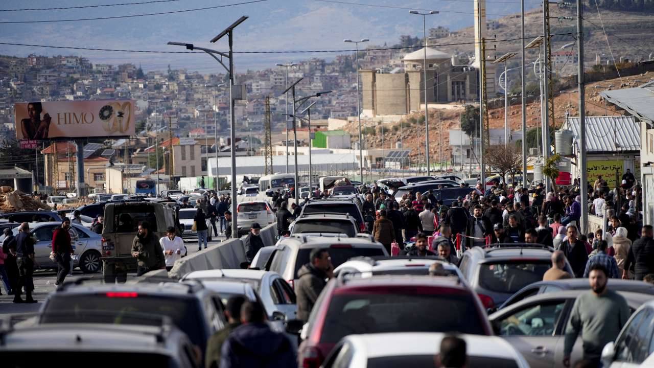 People make their way as they attempt to cross into Lebanon at the Masnaa border crossing between the Lebanon and Syria