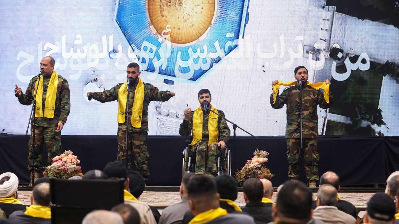 Hezbollah veterans perform on stage before Lebanon's Hezbollah leader Sayyed Hassan Nasrallah addresses his supporters via a screen during a rally in Beirut's southern suburbs
