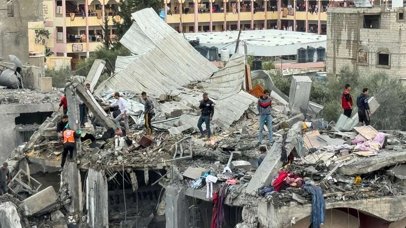 Palestinians search for casualties at the site of Israeli strikes on a house in Rafah