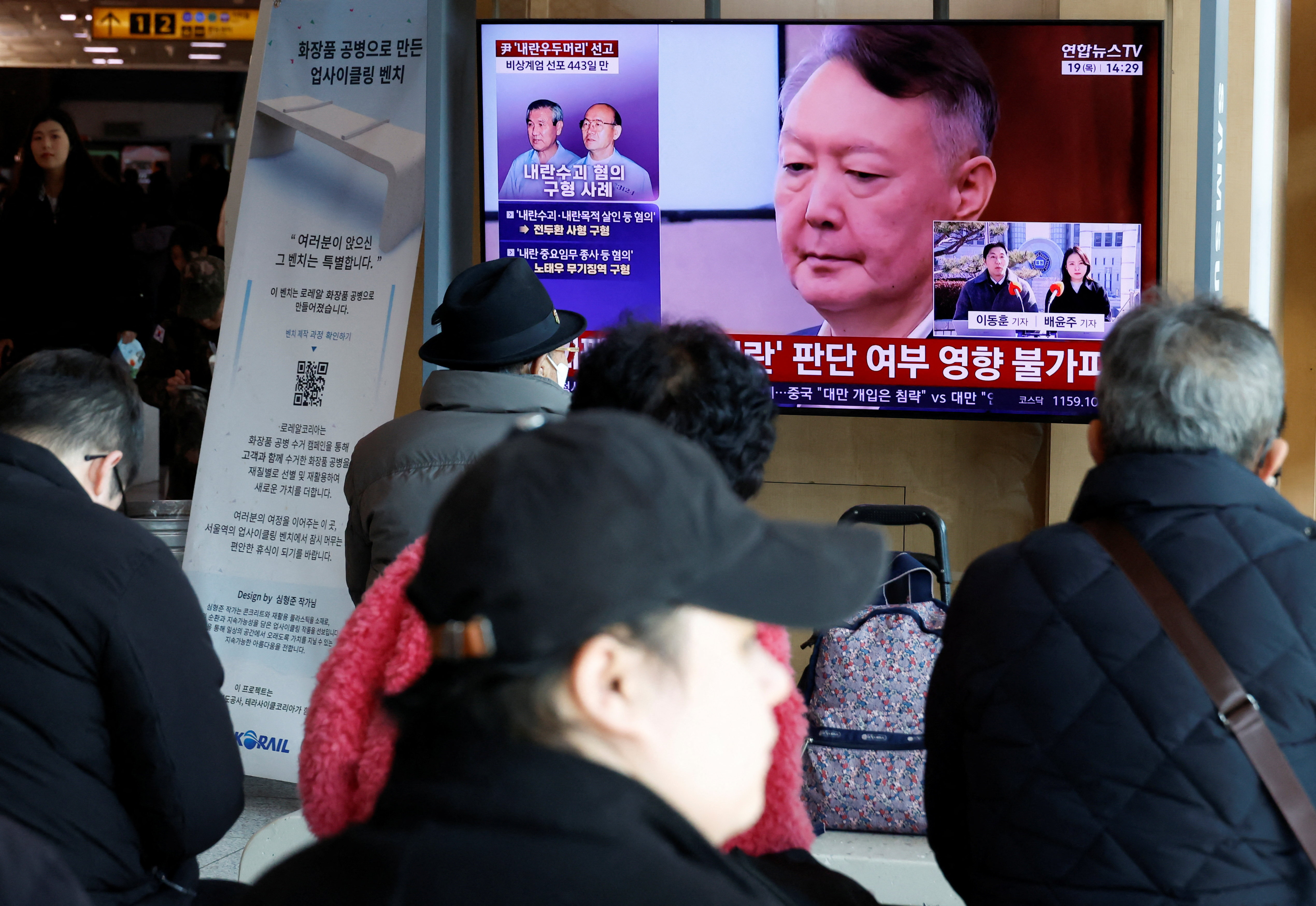 People watch a news report on the sentencing trial of South Korean former president Yoon Suk Yeol's insurrection case in Seoul