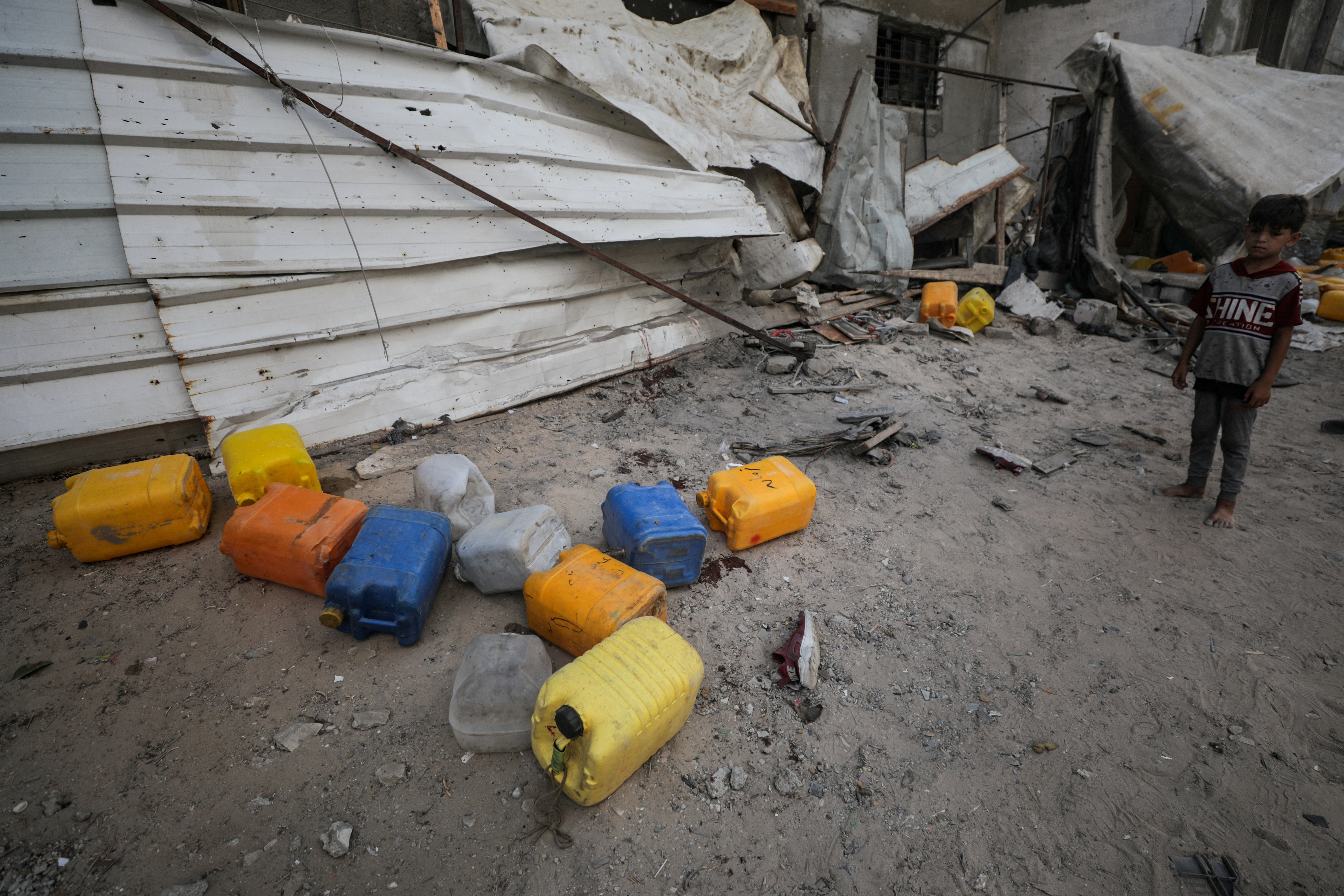 Aftermath of an Israeli strike that killed Palestinians, who gathered to collect water from a distribution point, in Nuseirat