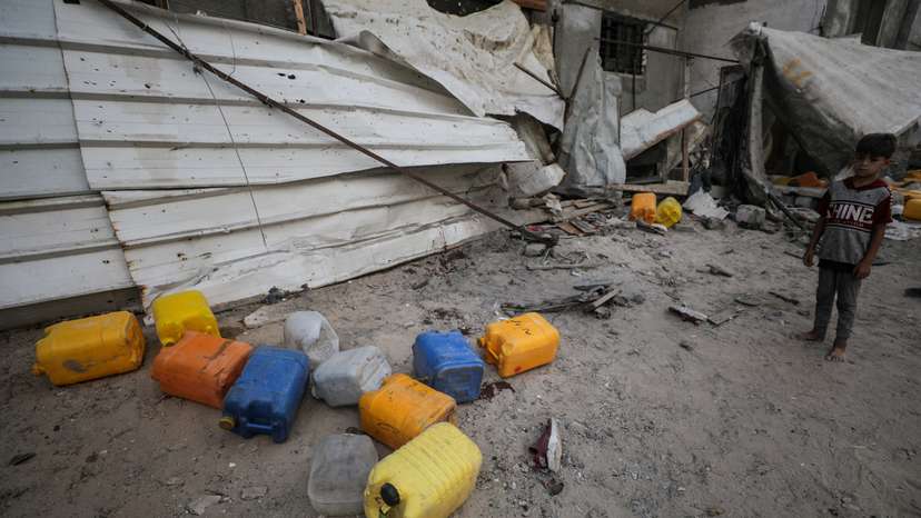 Aftermath of an Israeli strike that killed Palestinians, who gathered to collect water from a distribution point, in Nuseirat