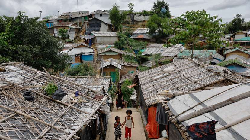 Rohingya refugee children walk along at the Kutupalang refugee camp in Cox's Bazar