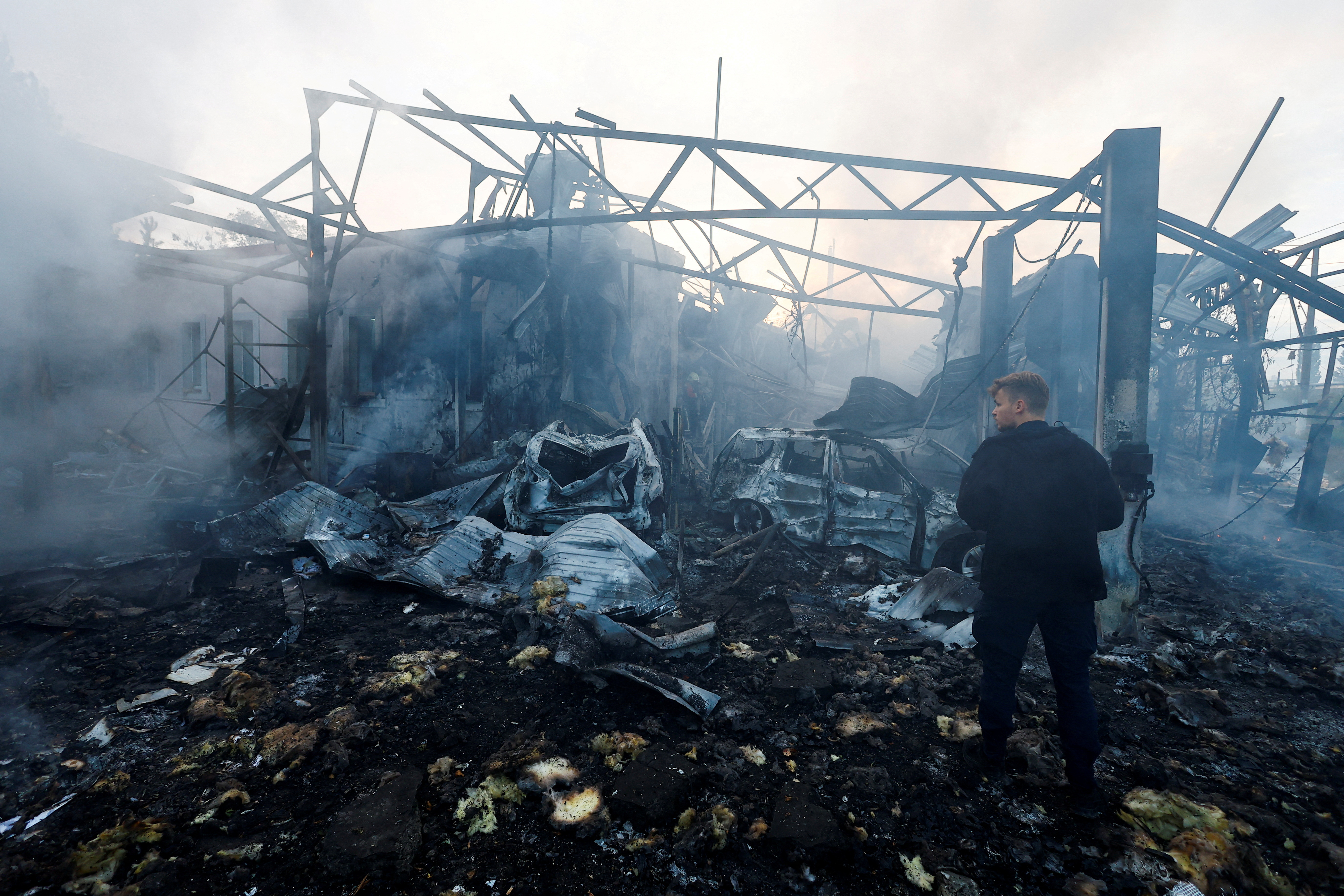 Firefighters work at a site damaged during a Russian missile strike, in Kyiv