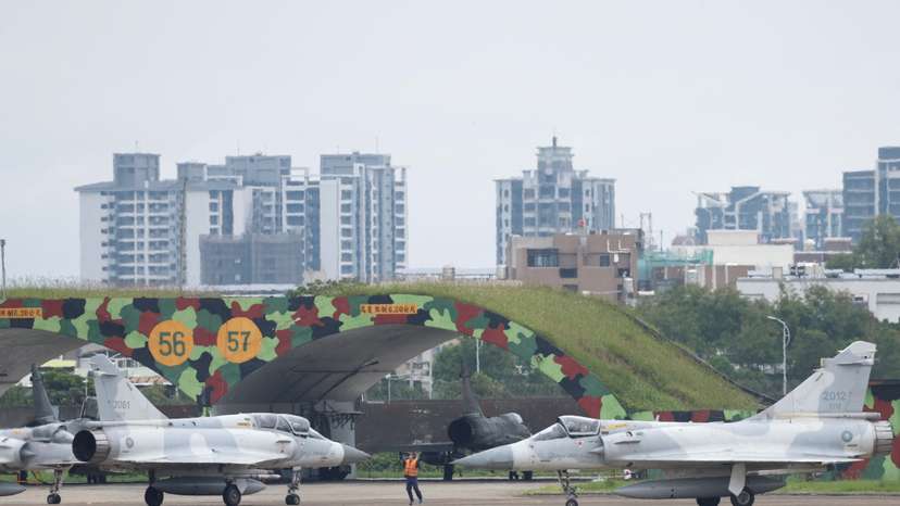A ground staff gesture to Taiwan Air Force Mirage 2000-5 aircraft as preparing to take off at Hsinchu Air Base, in Hsinchu