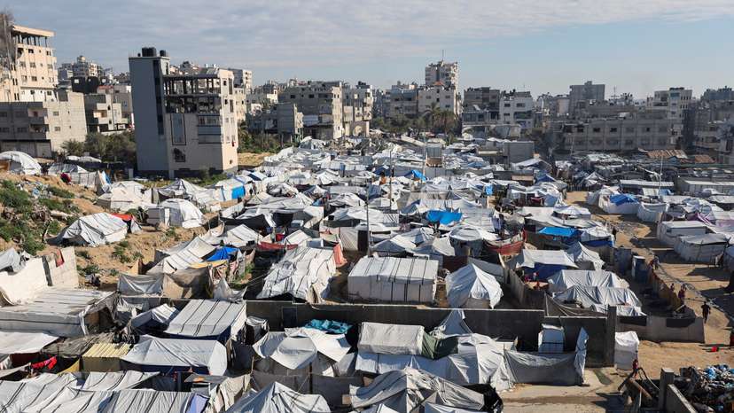 Palestinians displaced during the two-year Israeli offensive, shelter at a tent camp in Gaza City