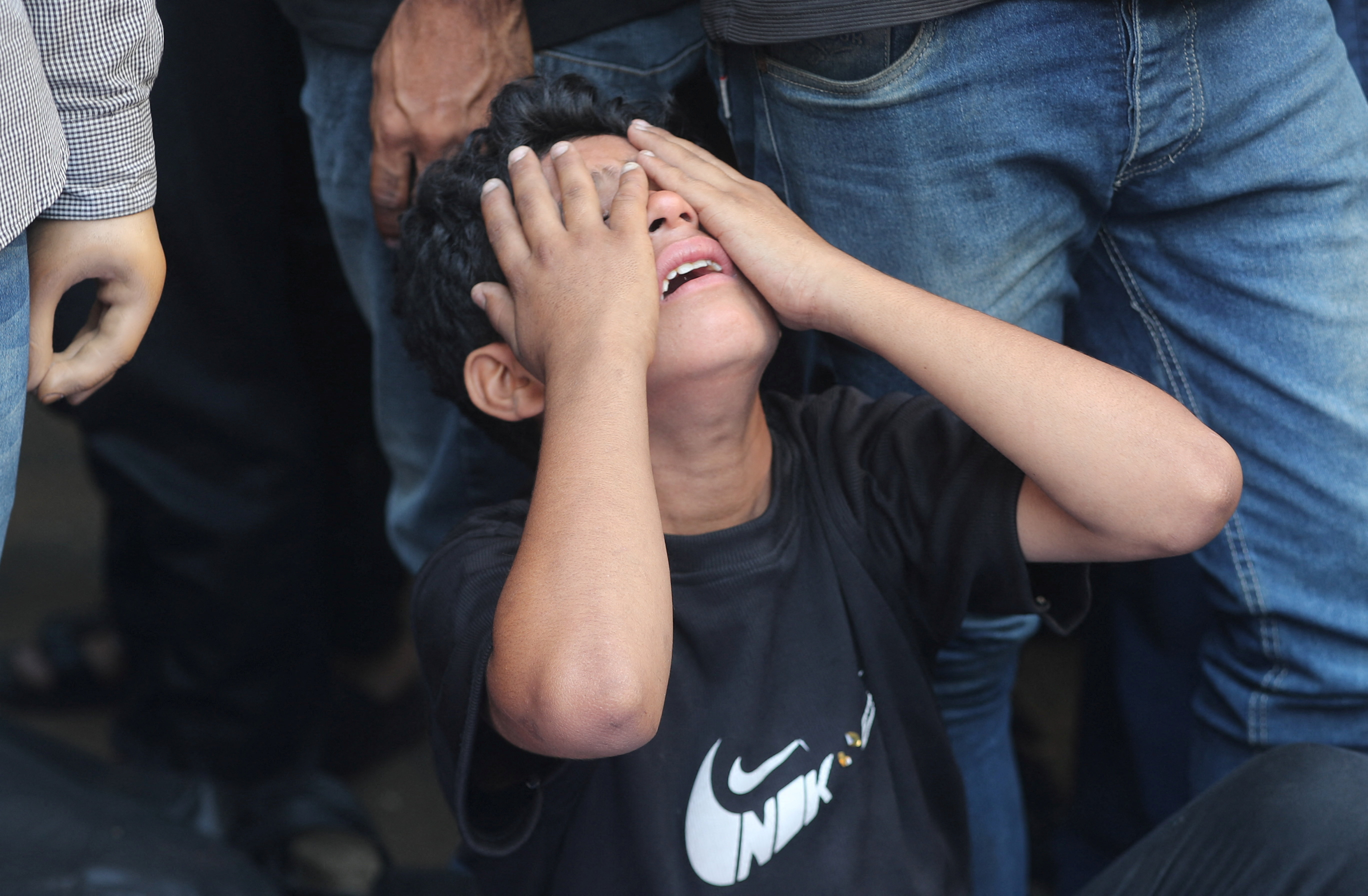Mourners react during the funeral of Palestinians killed in Israeli strikes, according to medics, at Al-Shifa Hospital in Gaza City