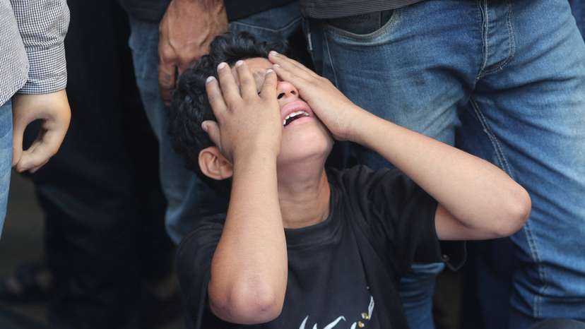 Mourners react during the funeral of Palestinians killed in Israeli strikes, according to medics, at Al-Shifa Hospital in Gaza City