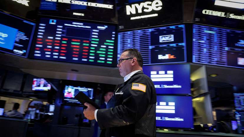 FILE PHOTO: Traders work on the floor of the NYSE in New York