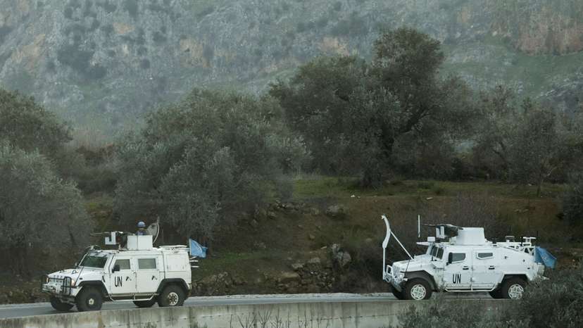 FILE PHOTO: UN peacekeepers (UNIFIL) vehicles ride along a street in Marjaayoun