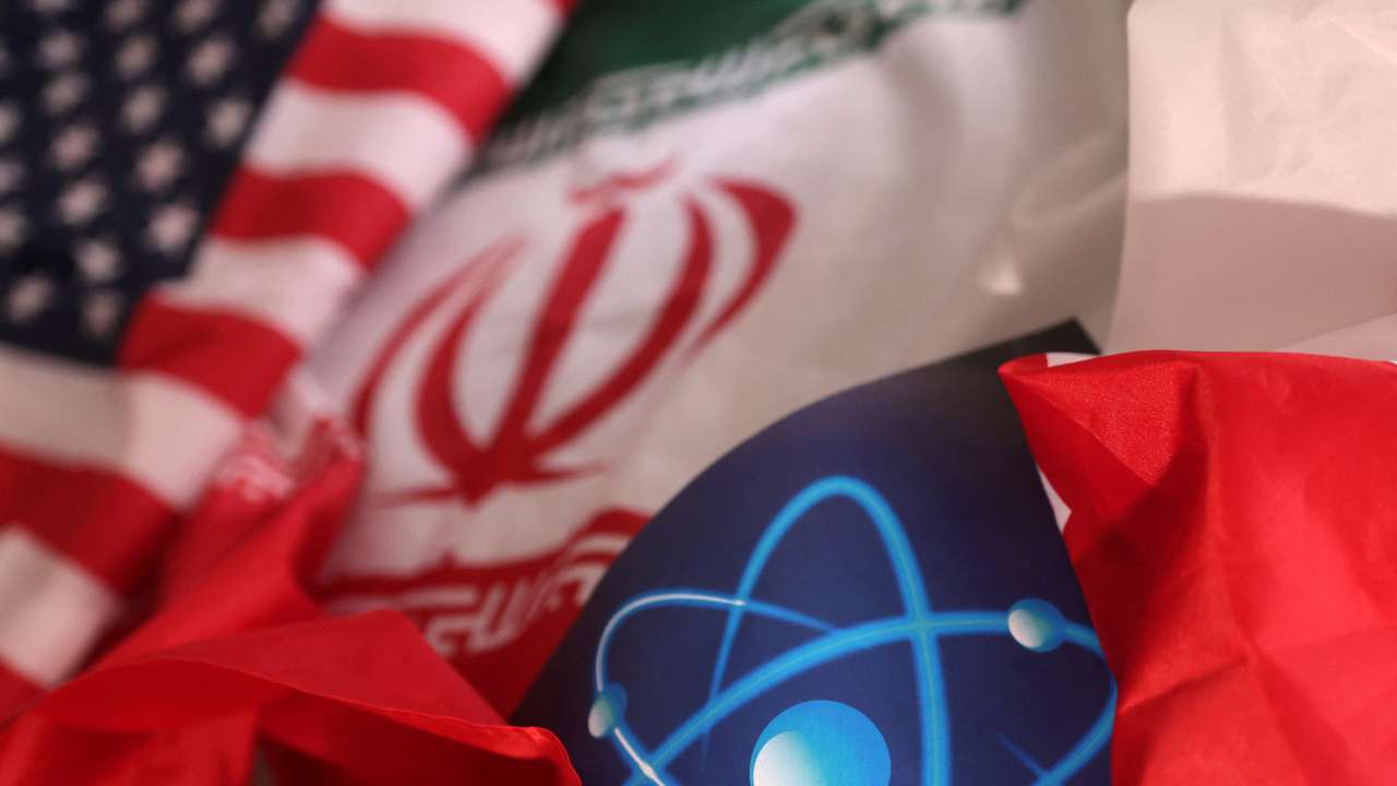 Illustration shows atomic symbol and USA and Iranian flags