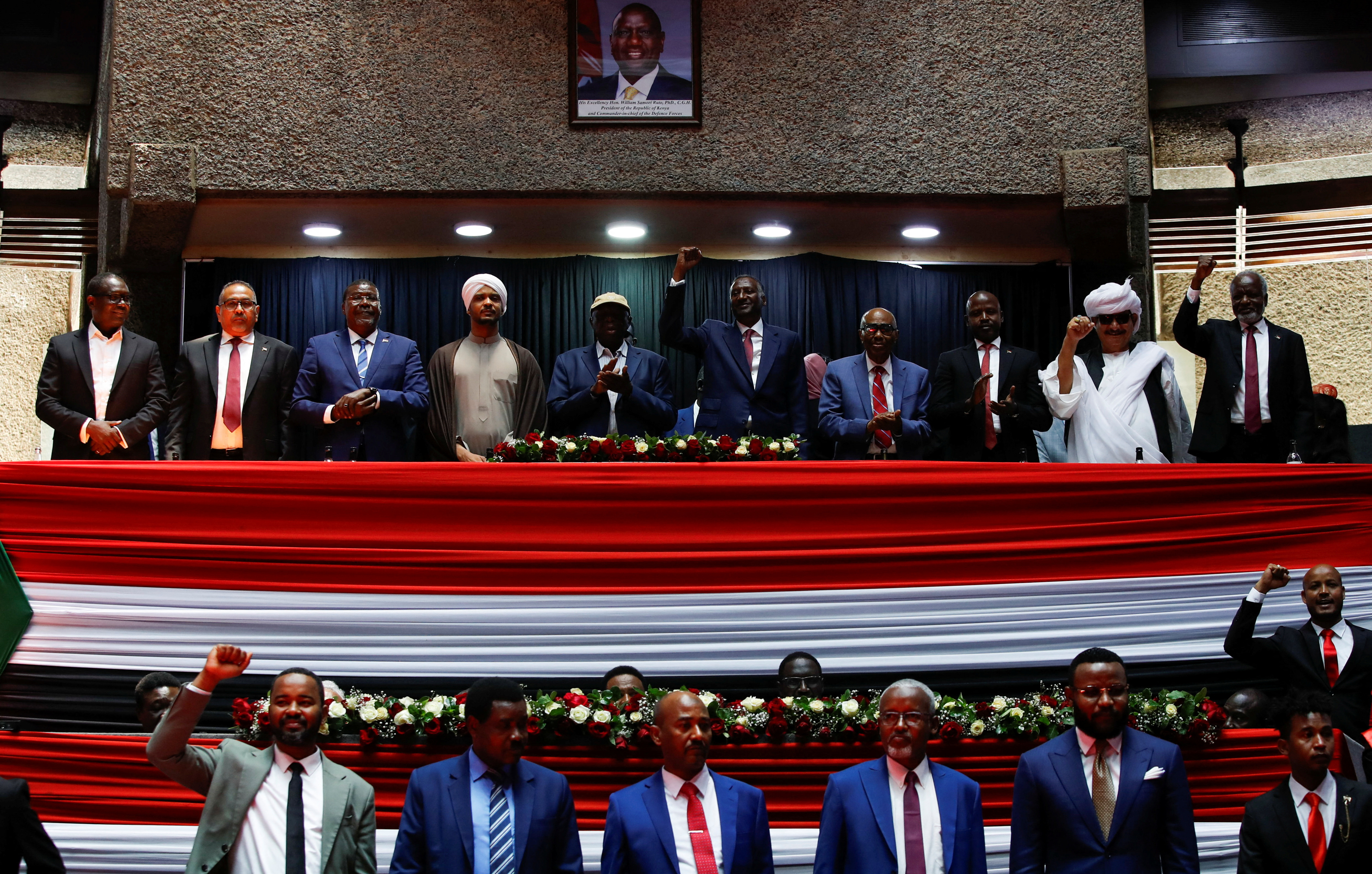 Delegates affiliated to Sudan's Rapid Support Forces (RSF) react during a meeting in Nairobi