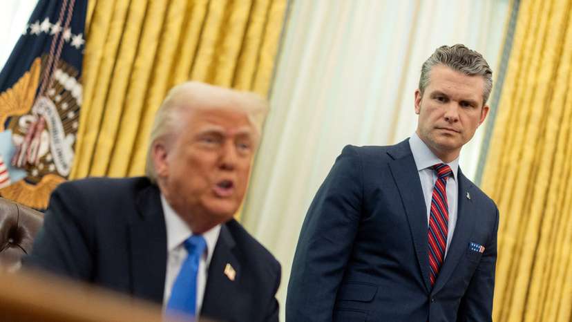 FILE PHOTO: U.S. Defense Secretary Pete Hegseth speaks next to President Donald Trump, in the Oval Office at the White House, in Washington, D.C.