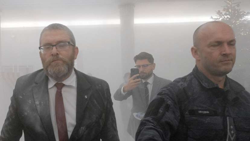FILE PHOTO: Grzegorz Braun, far-right Polish lawmaker from Confederation party, walks after using a fire extinguisher to put out Hanukkah candles at the parliament in Warsaw