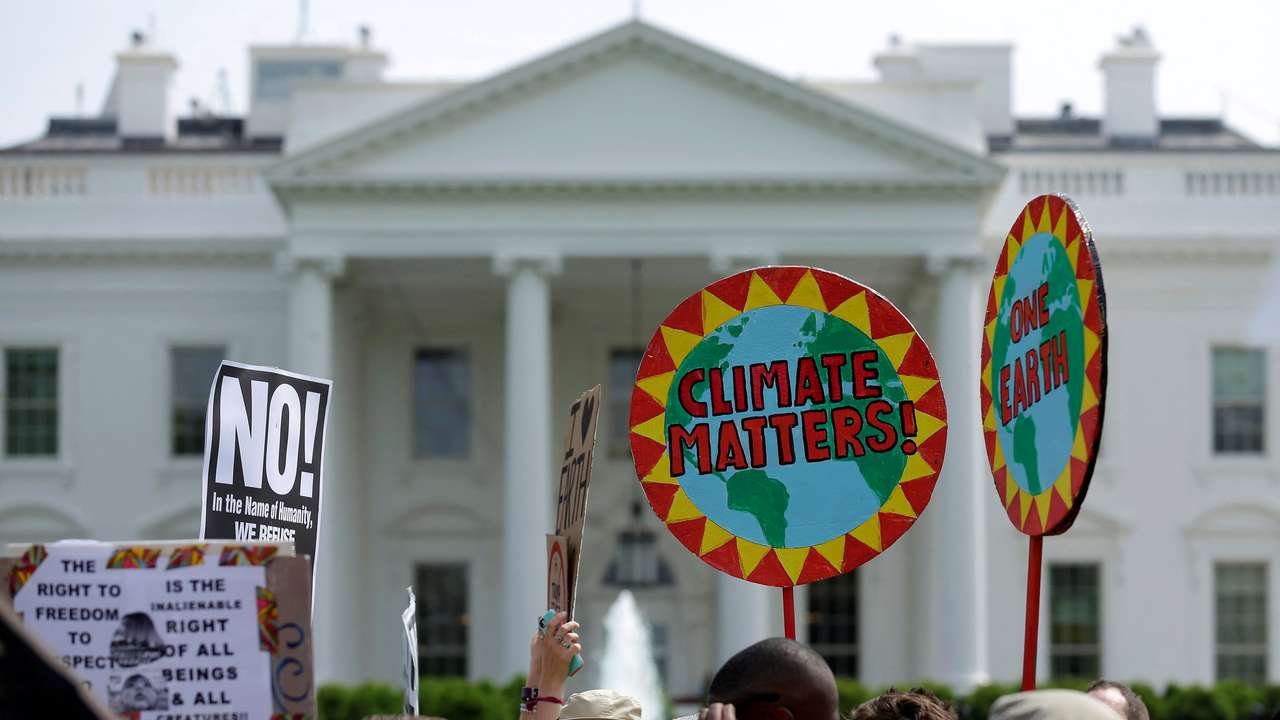 FILE PHOTO: Protesters carry signs during the Peoples Climate March at the White House in Washington