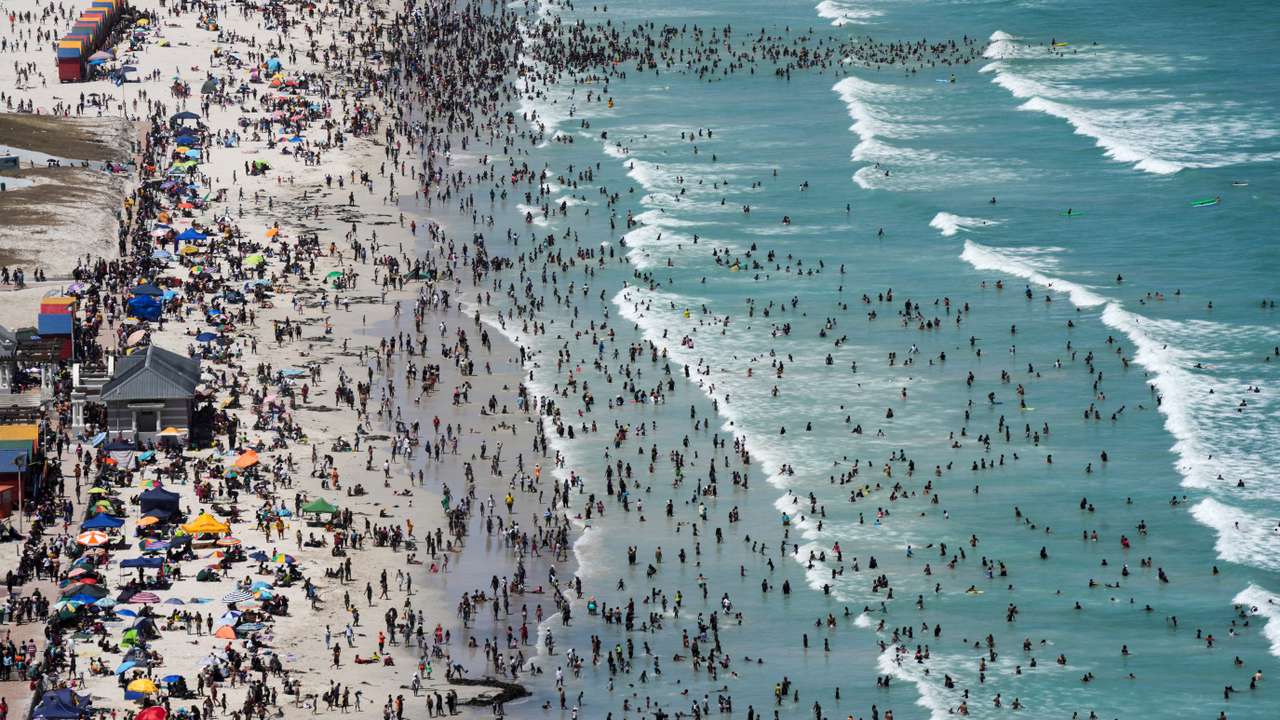 People enjoy the beach on Boxing Day, in Cape Town