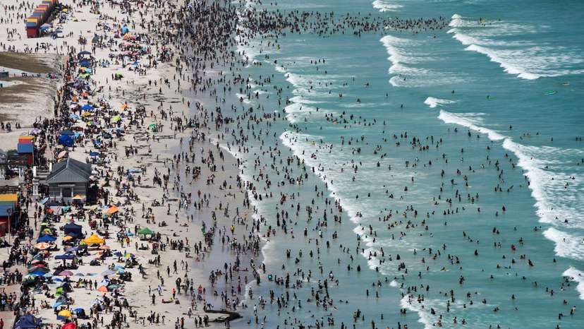 People enjoy the beach on Boxing Day, in Cape Town