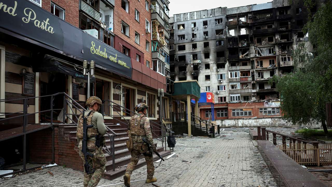 FILE PHOTO: Ukrainian police officers try to persuade residents to evacuate in the frontline town of Pokrovsk