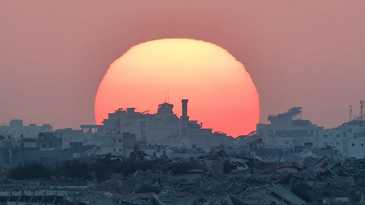 The sun sets over Gaza, as seen from the Israeli side of the border between Gaza and Israel
