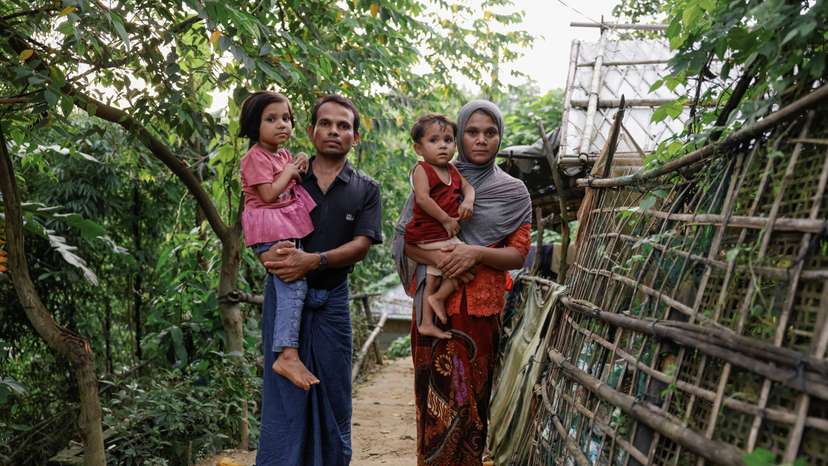 Saifur Rahman and his family, who said they fled from Buthidaung to Bangladesh, pose for a picture at a refugee camp in Cox's Bazar