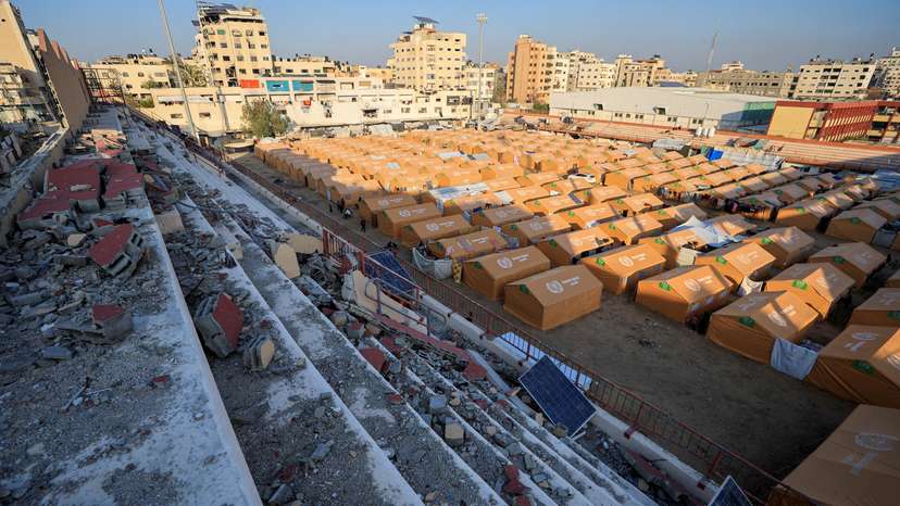 FILE PHOTO: Displaced Palestinians take shelter in a tent camp set up at Palestine Stadium, which was damaged during the Israeli offensive, in Gaza City
