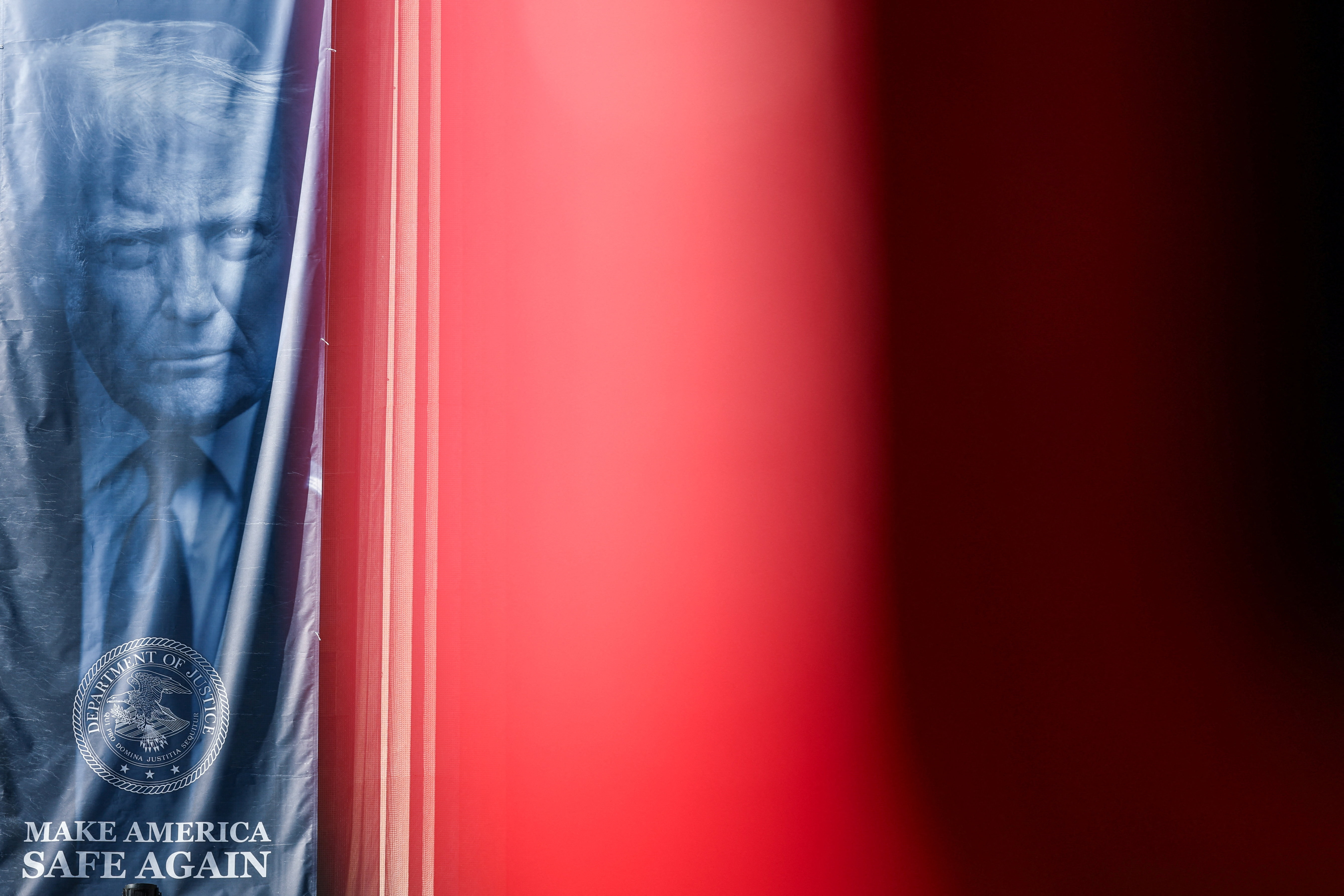 A banner depicting U.S. President Donald Trump hangs outside the Department of Justice building in Washington