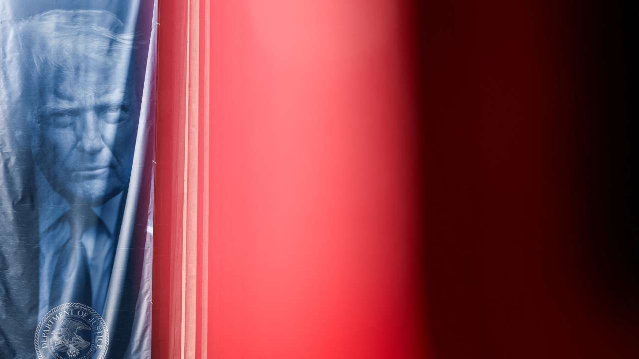 A banner depicting U.S. President Donald Trump hangs outside the Department of Justice building in Washington