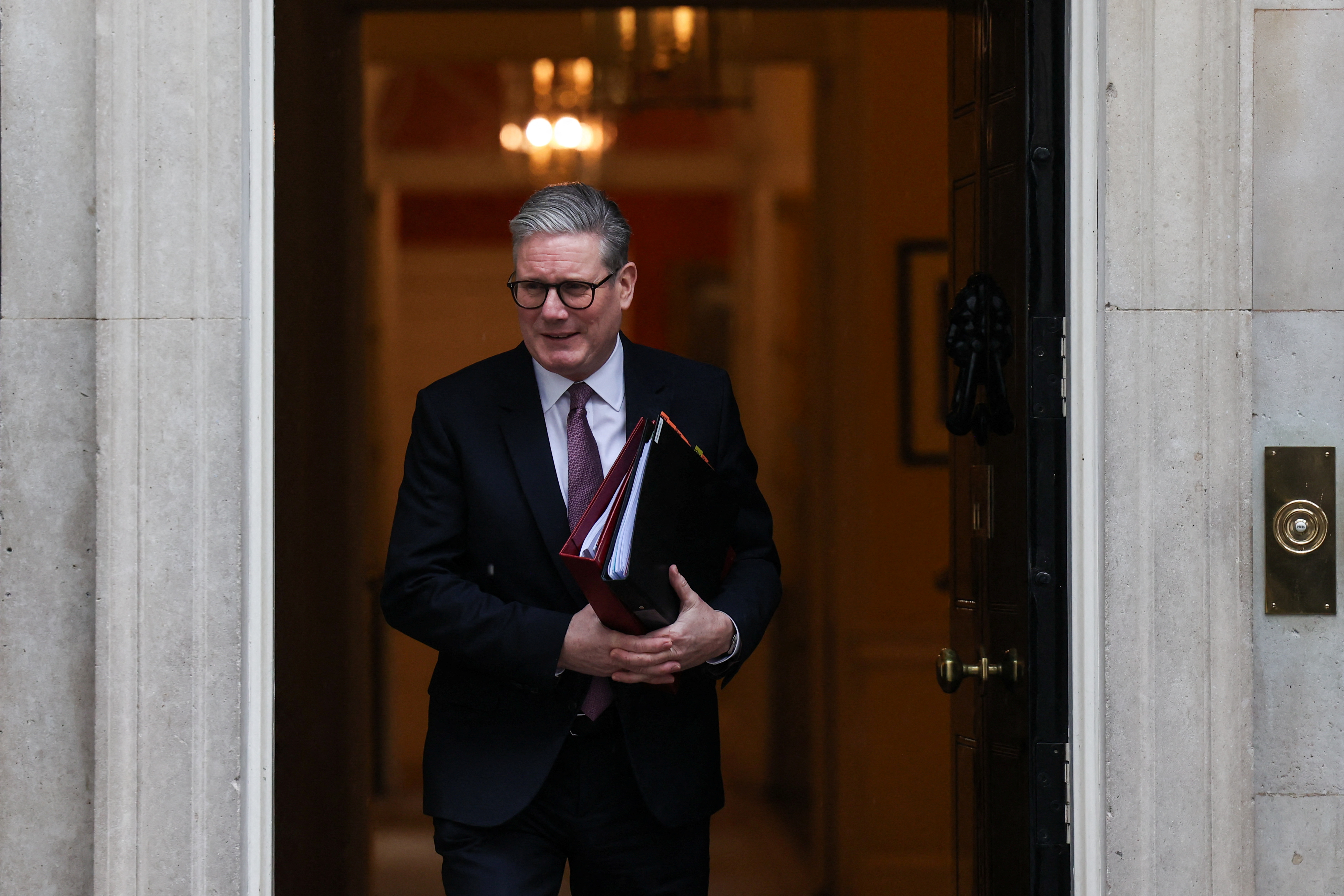 British Prime Minister Keir Starmer walks in front of 10 Downing Street in London