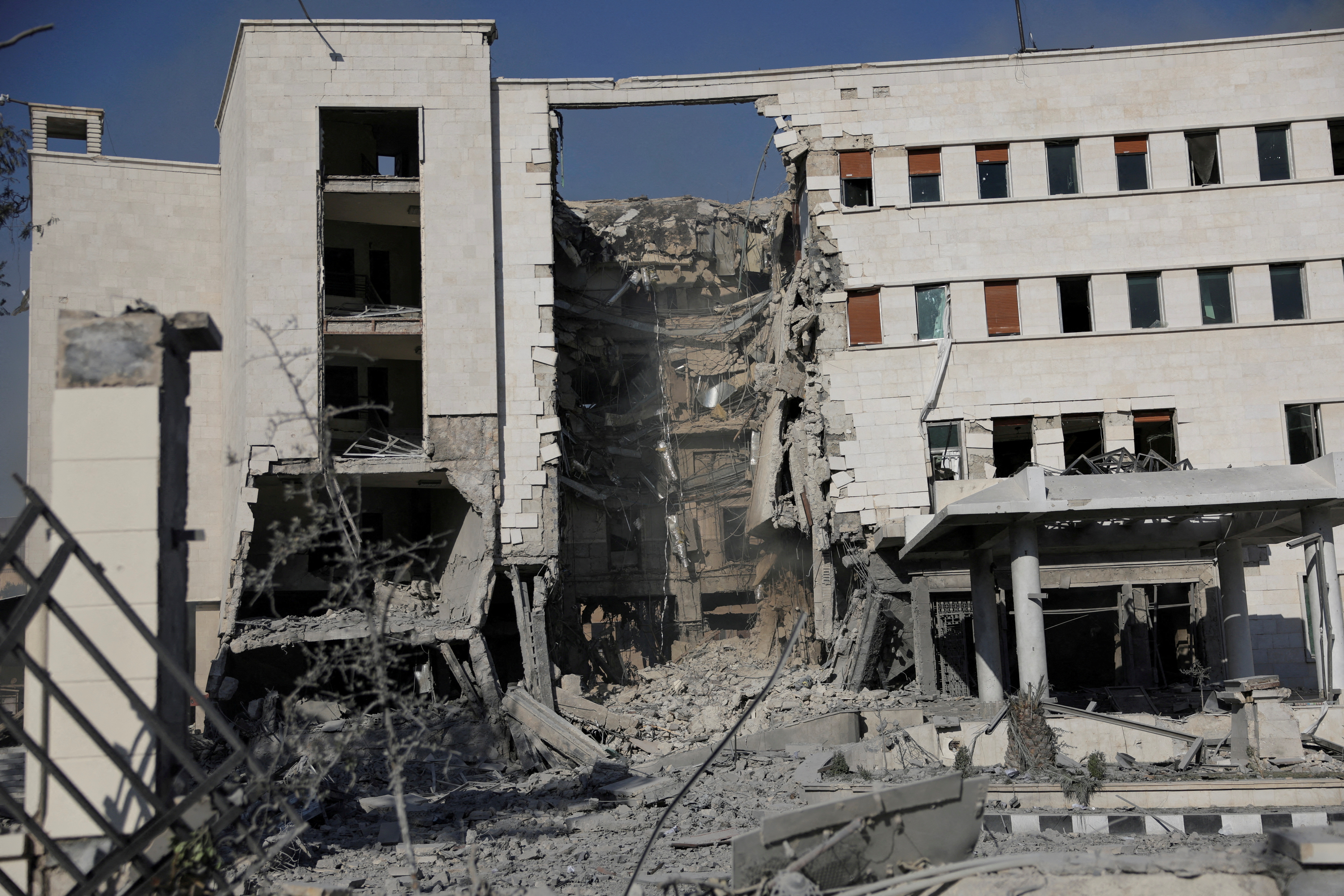 FILE PHOTO: People gather near a damaged site, in Damascus