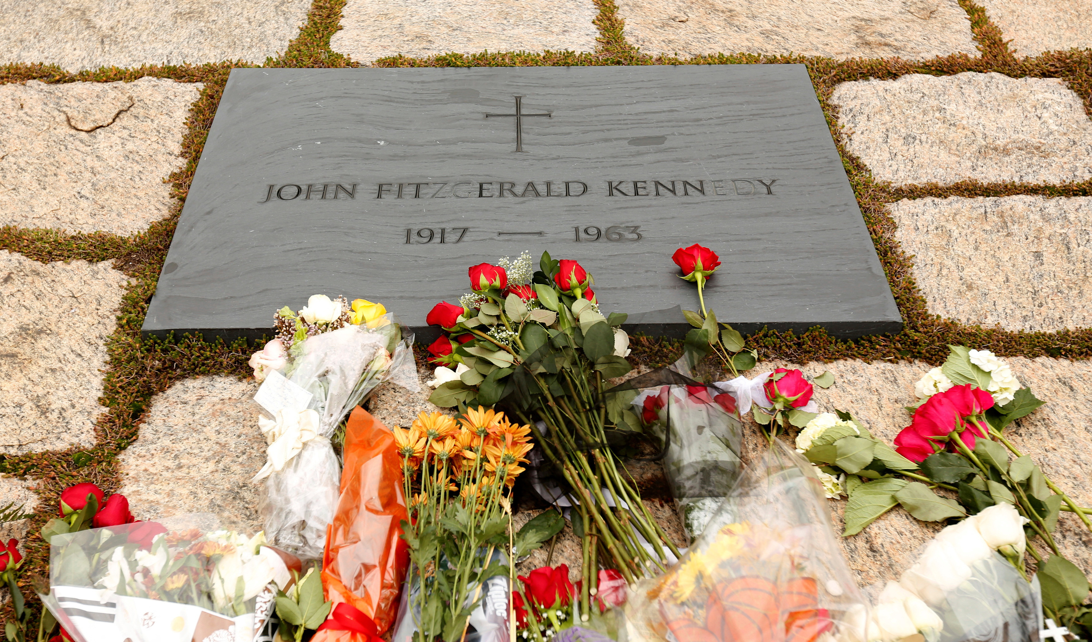 FILE PHOTO: Flowers adorn Kennedy's grave in Arlington on the 50th anniversary of his assassination